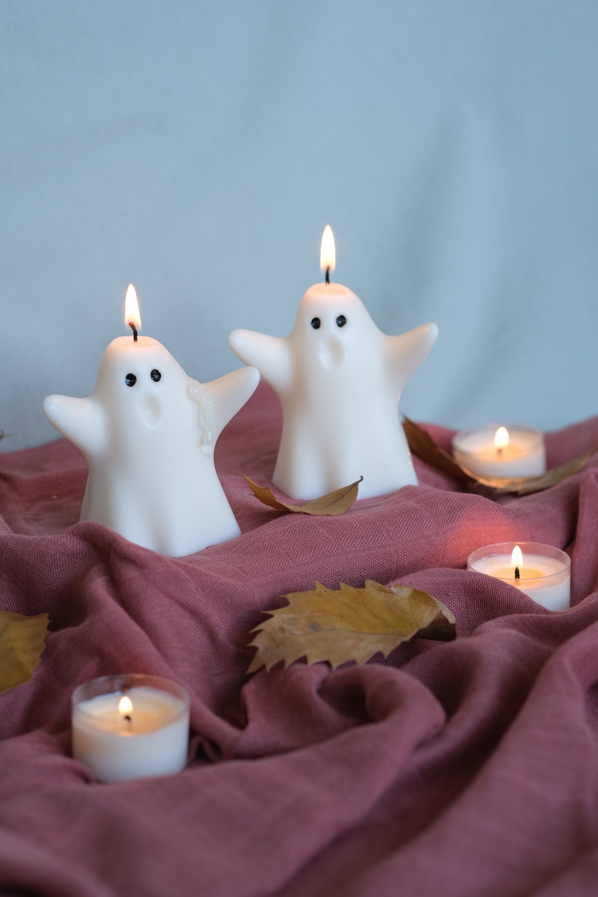 Group of handmade white soy wax ghost candles for Halloween