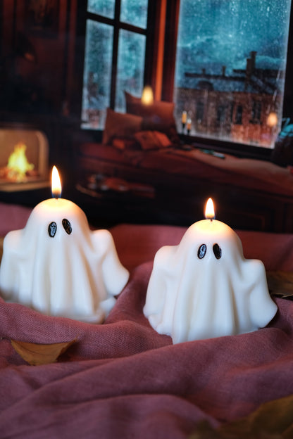 Group of handmade white soy wax ghost candles for Halloween