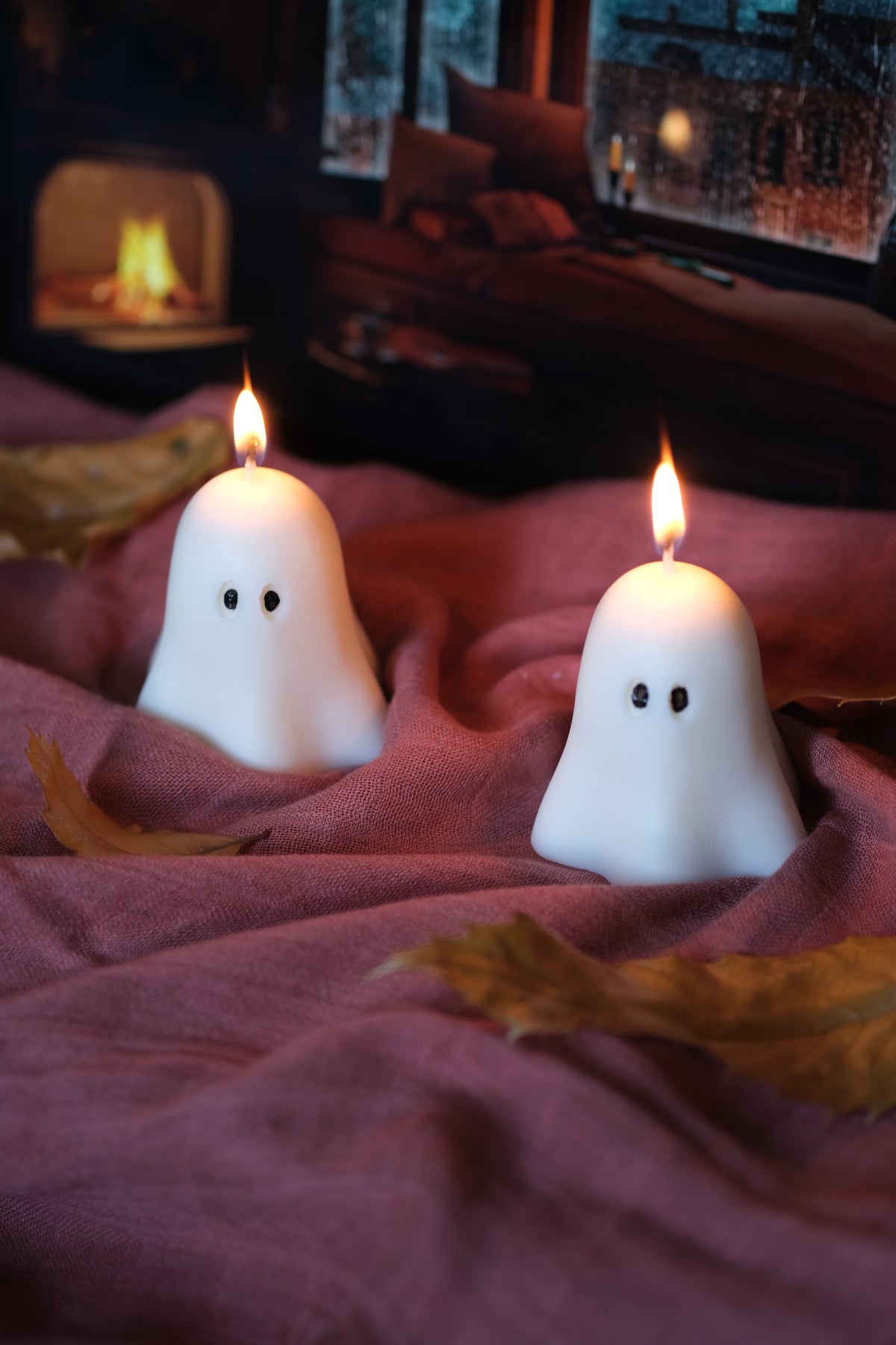 Group of handmade white soy wax ghost candles for Halloween