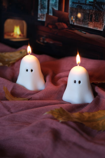 Group of handmade white soy wax ghost candles for Halloween