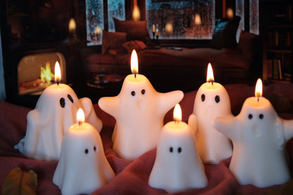 Group of handmade white soy wax ghost candles for Halloween