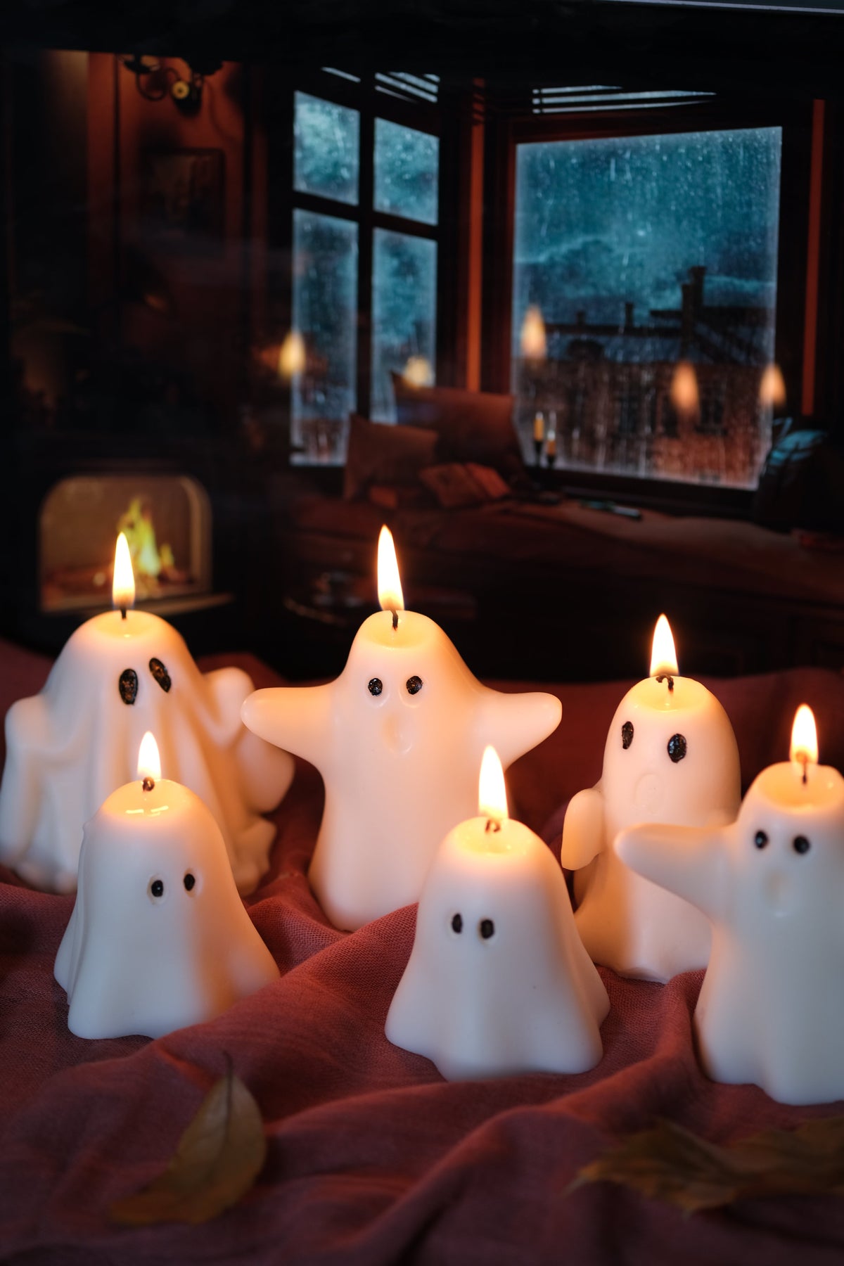 Group of handmade white soy wax ghost candles for Halloween