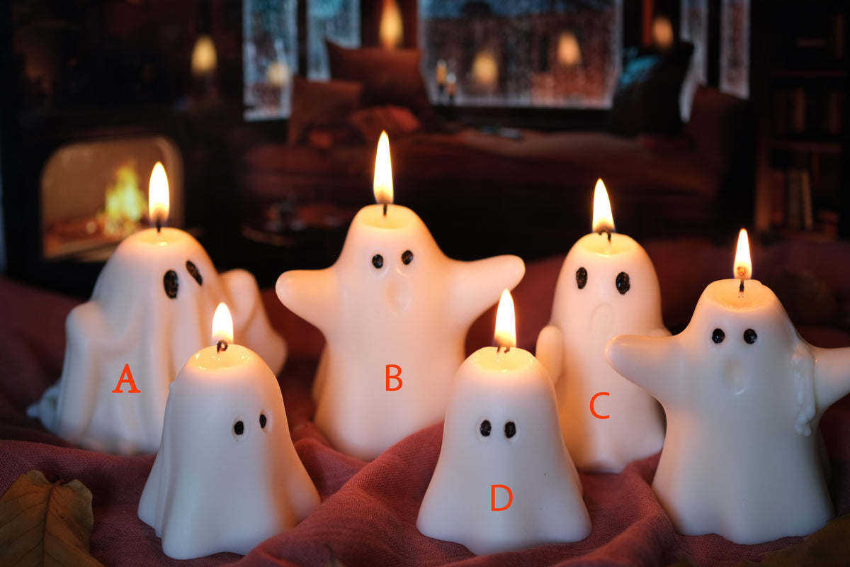 Group of handmade white soy wax ghost candles for Halloween