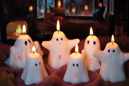 Group of handmade white soy wax ghost candles for Halloween