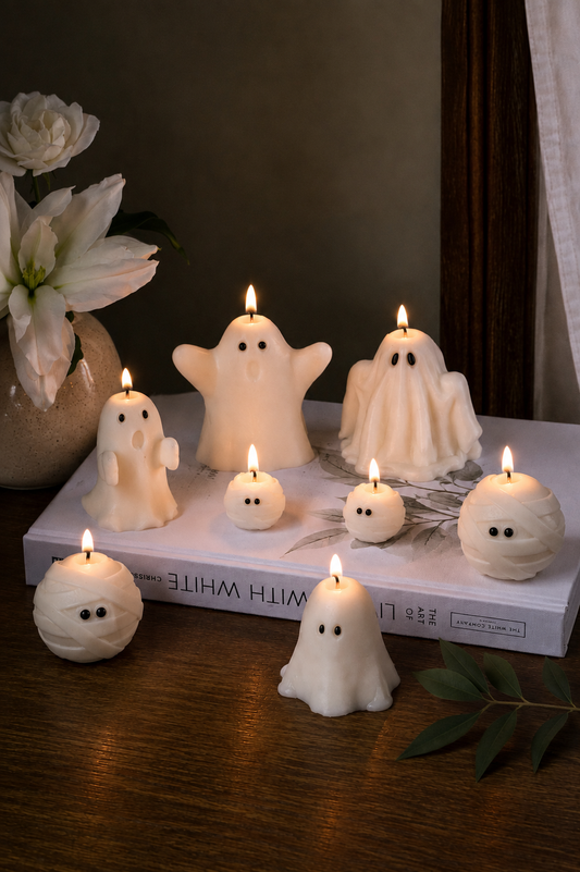 Group of handmade white soy wax ghost candles for Halloween